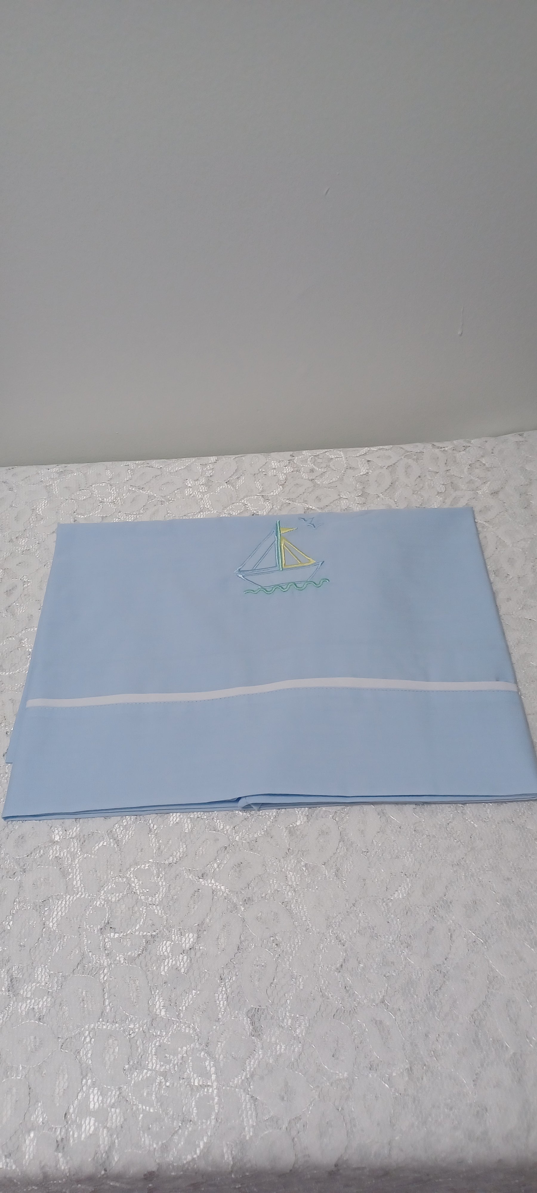 Blue Blanket With Embroidery Sailboat And White Trim